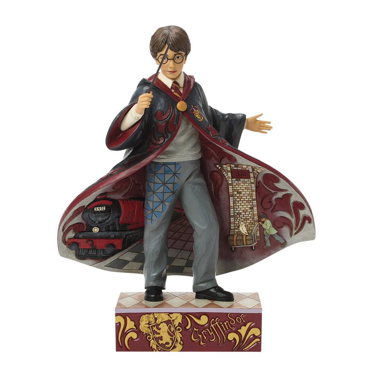 Figurine Harry Potter Jim Shore en tenue de Gryffondor, baguette levée, cape déployée avec Poudlard Express et quai 9¾ sculptés en relief.