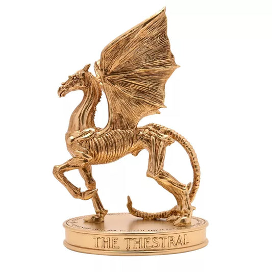 Figurine Sombral dorée Harry Potter avec ailes déployées sur socle gravé de la collection Herbology